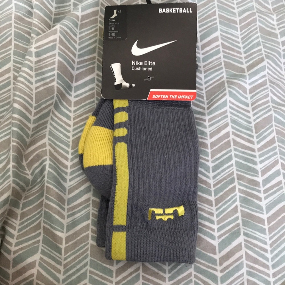 Grey and yellow Nike elite dri-fit socks.